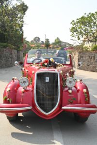 a decorate red vintage car available for wedding