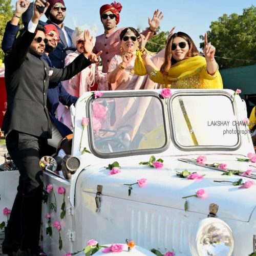 Indian Grroom dancing on his way to wedding on white vintage car